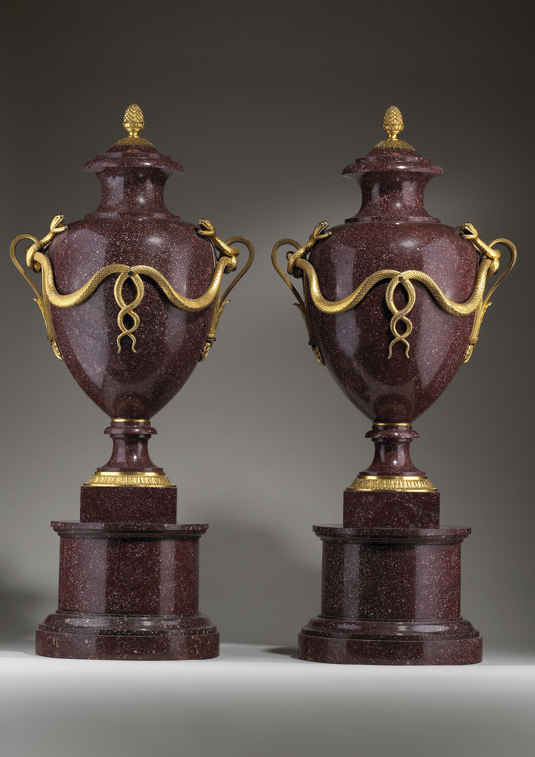 A Pair of Ormolu-mounted Imperial Porphyry Urns and Covers on Stands